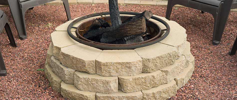 Custom stacked stone wood burning fire pit at a home in South Bend, IN.