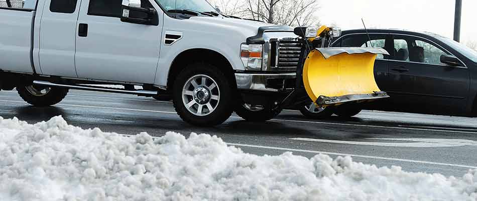 Work truck with snow plow attachment dispatched to remove snow at a commercial property in Granger, IN.