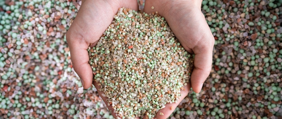 Mixture of granular fertilizer in professionals hands in Elkhart, IN.