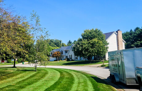 lawn-treatment-05 Hey, beautiful day with a blue sky and a freshly cut lawn in residential area